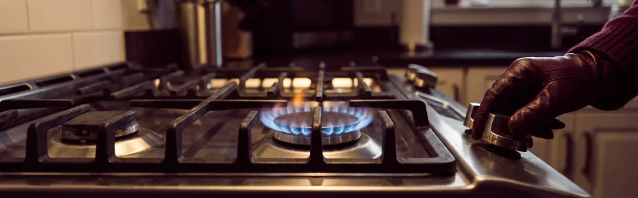 Close view of a blue gas flame on a single burner